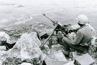 A machine gunner of the 101st Airborne sits with a commanding view near Tuy Hoa (II Corps).