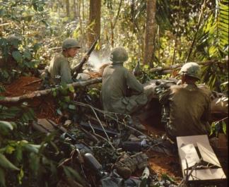 Three soldiers of the 173rd Airborne take a rest from their assault on Hill 875, near Dak To (Central Highlands).
