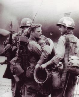 A Radioman comforts his friend who had just survived a battle during Operation Byrd in which nearly his entire platoon was wiped out.