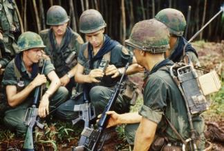 A rifle squad of the 1st Battalion, 2nd Infantry, 1st Infantry Division stop to examine a PRT-4 radio transmitter and PRR-9 receiver.