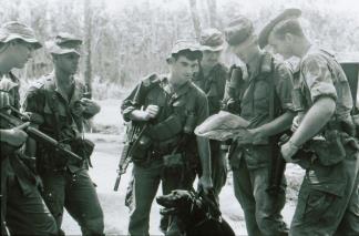 Members of the 61st Combat Tracker Team attached to the 1st Infantry Division are briefed prior to a patrol near Lai Khe (III corps).