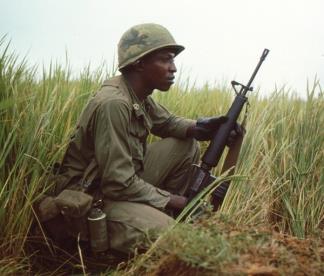 A Staff Sergeant of Company B, 1st Battalion, 505th Infantry, 82nd Airborne scans the terrain ahead whilst a on patrol in early 1968.