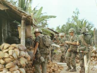 Members of the 47th Infantry, 2d Brigade, 9th Infantry Division search a village near Ben Tre.