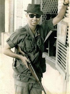 Louis Galanos with his M2 Carbine in front of the classified documents office at the United States Army Support Command in Qui Nhon.