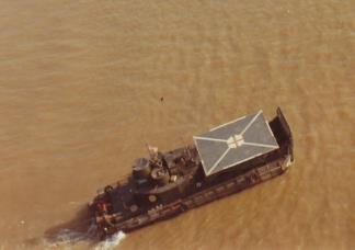 An aerial view of an Aid Boat- an Armored Troop Carrier (ATC) with a helicopter landing pad fitted over the foredeck.