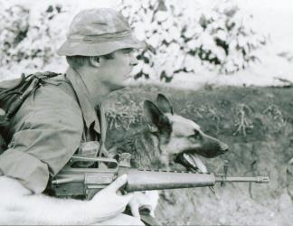 A Scout-Dog Handler with the 3rd Brigade, 4th Infantry Division wears a locally made camouflage boonie hat.