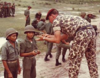 Vietnamese Rangers receive a course of instruction on demolitions from an advisor to the 77th Ranger Detachment.
