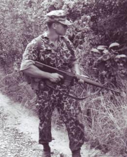 Captain Edward Rybat, 1st Special Forces Group, carries an M16 whilst on a patrol in War Zone "D", north of Ben Cat (III Corps).
