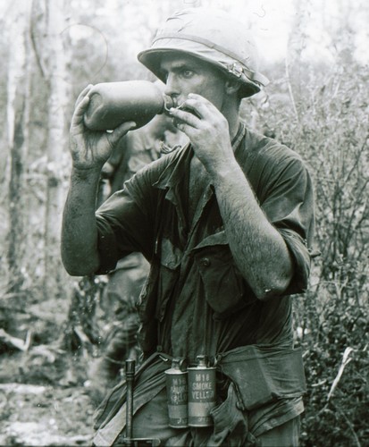 A member of the 1st Battalion, 501st Infantry, 101st Airborne slakes his thirst with a drink from a plastic 1-quart canteen.