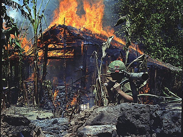 PFC Raymond Rumpa of 3rd Battalion, 47th Infantry, 9th Infantry Division carries an M67 90mm recoilless rifle during an attack on a VC base camp at My Tho in the Mekong Delta.