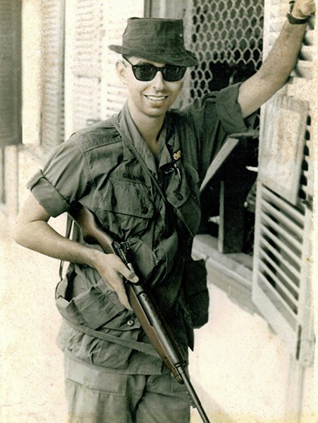 Louis Galanos with his M2 Carbine in front of the classified documents office at the United States Army Support Command in Qui Nhon.