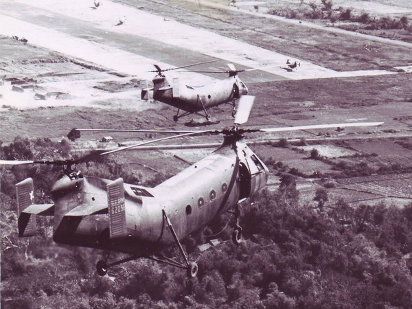 CH-21 helicopters returning to Soc Trang airfield after carrying ARVN troops on strikes against the Viet Cong.