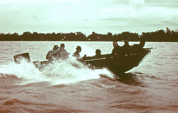 Vietnamese SEALs (Lien Doc Nguoi Nhia – LDNN) journey down a river in the Mekong Delta aboard a skimmer.