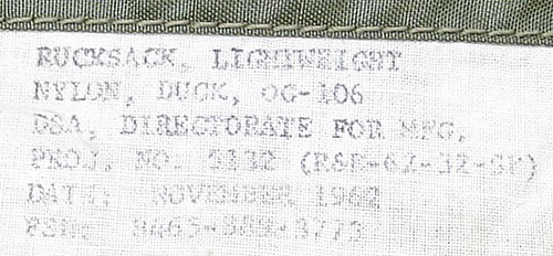 The experimental 1962 Lightweight Rucksack had a small printed label, whereas the contract information was stamped inside the pack on production versions.