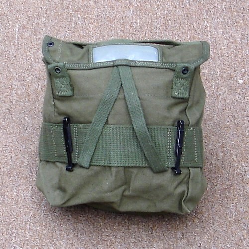 When not in use the item securing straps could be pushed back inside the M1956 field pack.