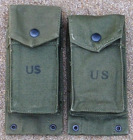 A 1967 dated 'long' ammunition pocket on the left and a 1962 'short' version on the right.