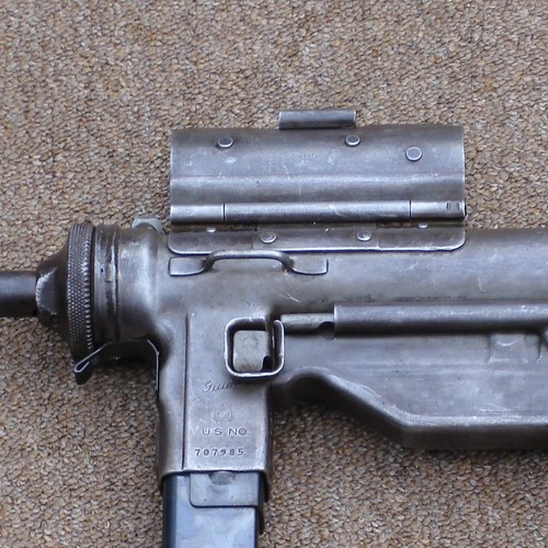 The magazine release catch on the M3A1 was positioned below the forward sling loop.