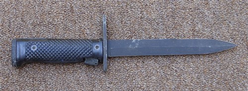 The M6 Bayonet had a 6-3/4 inch steel blade and a release latch at the base of the plastic grip.