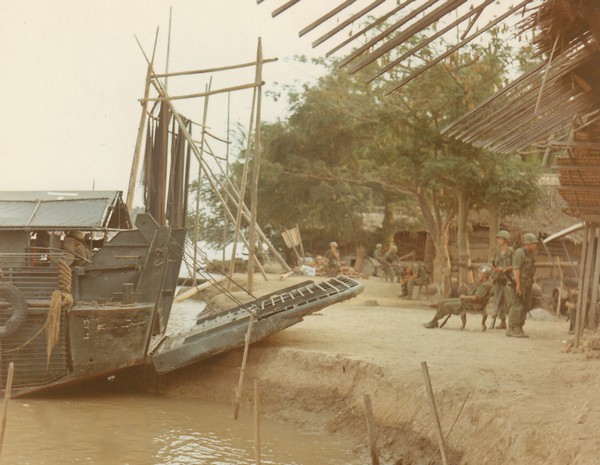 A Navy Armored Troop Carrier (ATC) waits near Ben Tra to take Company "A", 4th Battalion, 47th Infantry, 9th Infantry Division to another location along the river.