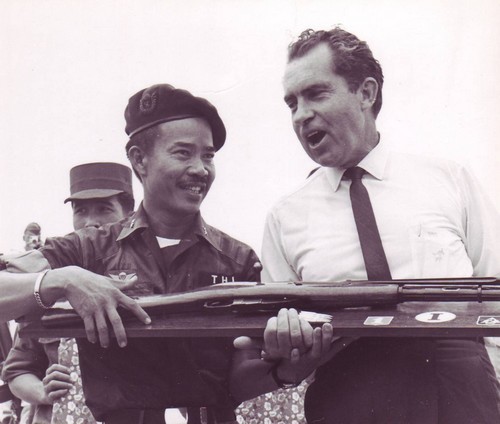 Brigadier General Nguyen Thi, commander of the Vietnamese I Corps, presents a captured Viet Cong rifle to Richard Nixon.