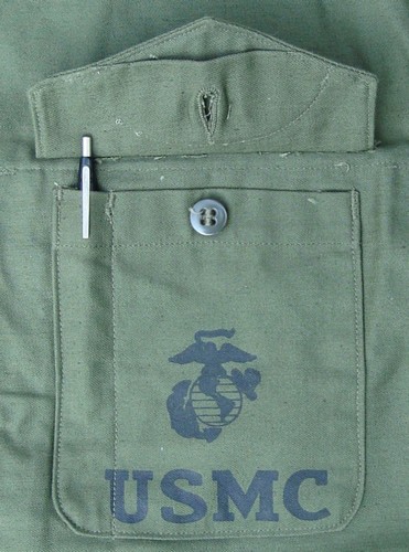 The left patch pocket of the P56 was stenciled  with the Marine Corps Eagle, Globe and Anchor (EGA) insignia.