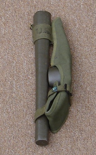The cotton carrier accomodated the detached metal head and wooden handle of the M1910 pick mattock.