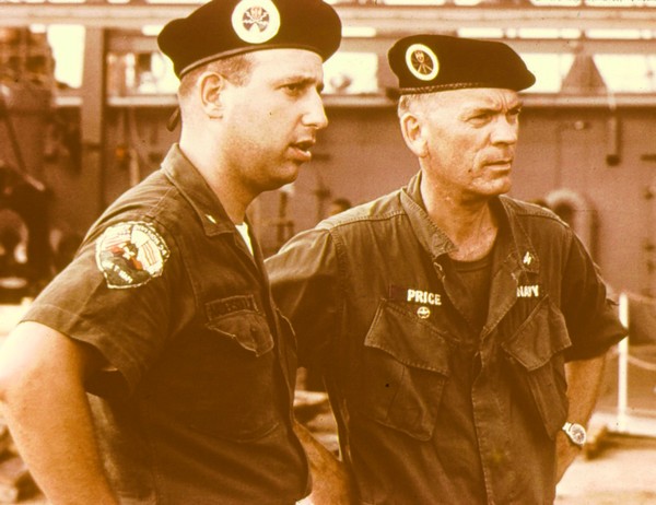 Captain Arthur Price, commander of the River Patrol Force (Task Force 116), confers with a sailor of River Assault Division 54.