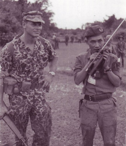 Special Forces Captain Edward Rybat and Vietnamese Lieutenant Huyen Phuoc Thoi use the radio to call in troops during a mission against the Viet Cong in war zone "D".