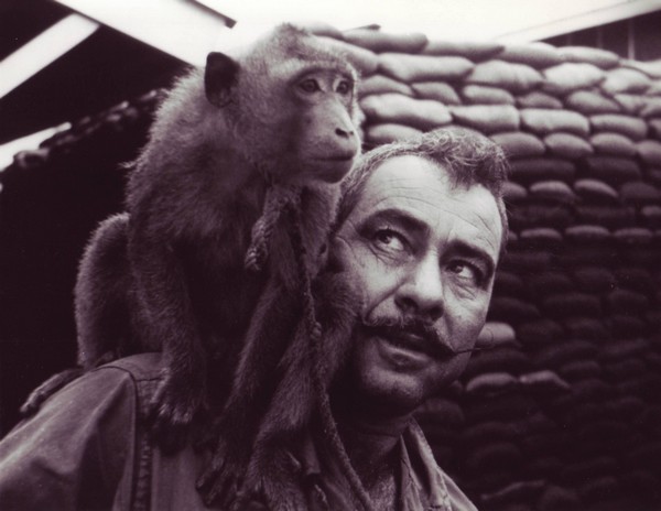 A SEAL team member gives his pet monkey a ride on his shoulder.