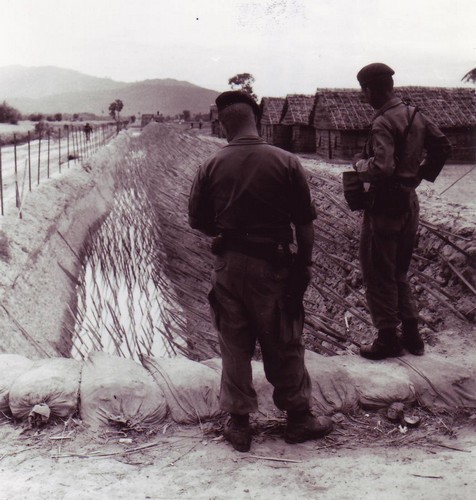 Sergeants Larry Manes and Raymond Echevarria of the A-14 Team, 5th Special Forces Detachment, inspect the punji stake defenses at the Chau-Lang CIDG camp in An Giang province, Mekong Delta (IV Corps).