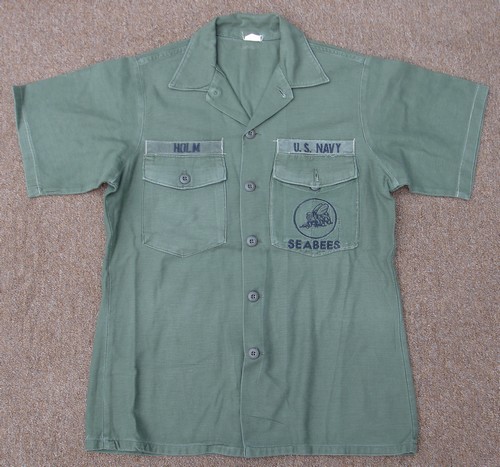 This 1964 pattern Utility Shirt features short sleeves and a locally embroidered version of the U.