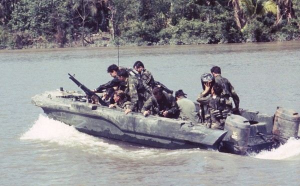 Members of SEAL Team One cruise down the Bassac River in a Seal Team Assault Boat (STAB).