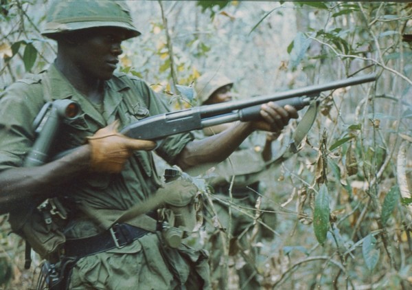 A member of the 2nd Battalion, 27th Infantry, 25th Infantry Division fires his pump action shotgun during Operation Junction City.