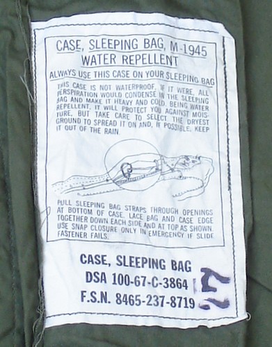 The label in the M1945 Sleeping Bag Case provided instructions on how to attach the case to the sleeping bag.