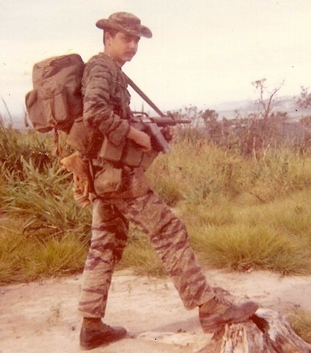 Clay Curtis, of the Special Mission Force, carries a CAR-15 rifle and CIDG rucksack whilst on an operation in the tri-border region.