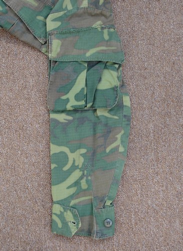 The lower cargo pockets of this ERDL 4th pattern jungle jacket have been removed and re-stitched onto the upper sleeves.